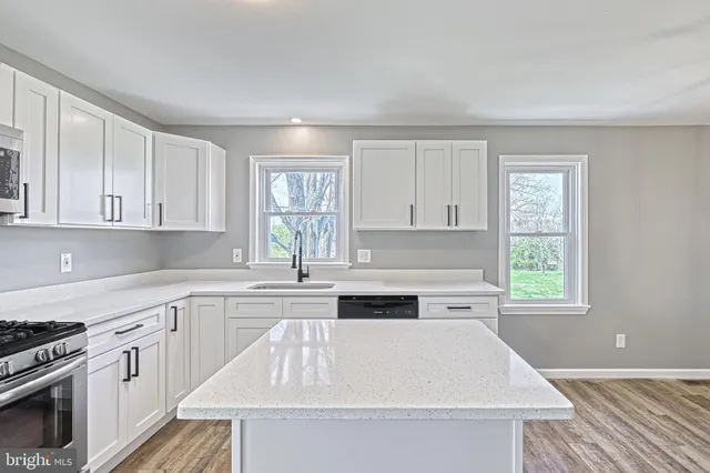 a kitchen with a stove and white cabinets