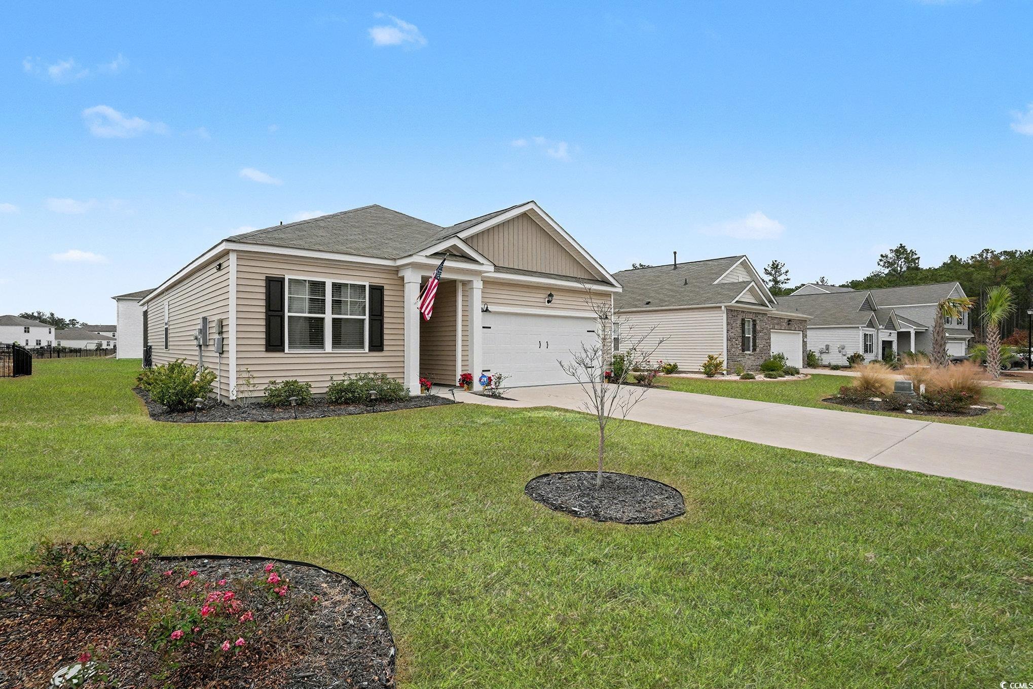 3923 Nandina Court Conway, SC 29526 - Photo 2 of 28 View of front of house with driveway, a front yard, a garage, and a shingled roof