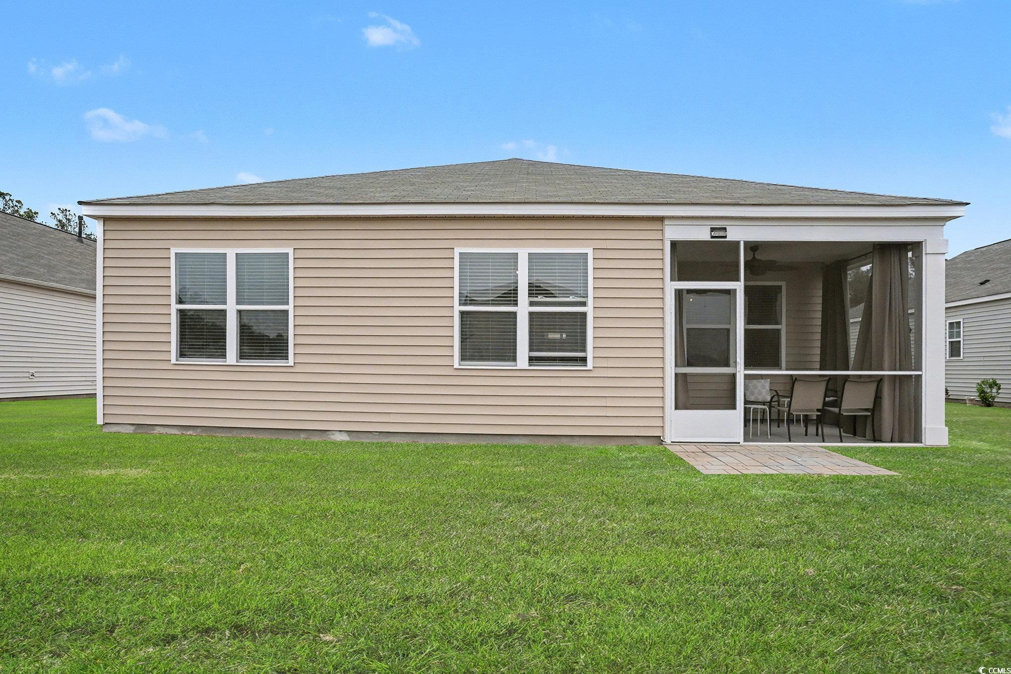 3923 Nandina Court Conway, SC 29526 - Photo 25 of 28 Back of house featuring a lawn, roof with shingles, and a sunroom