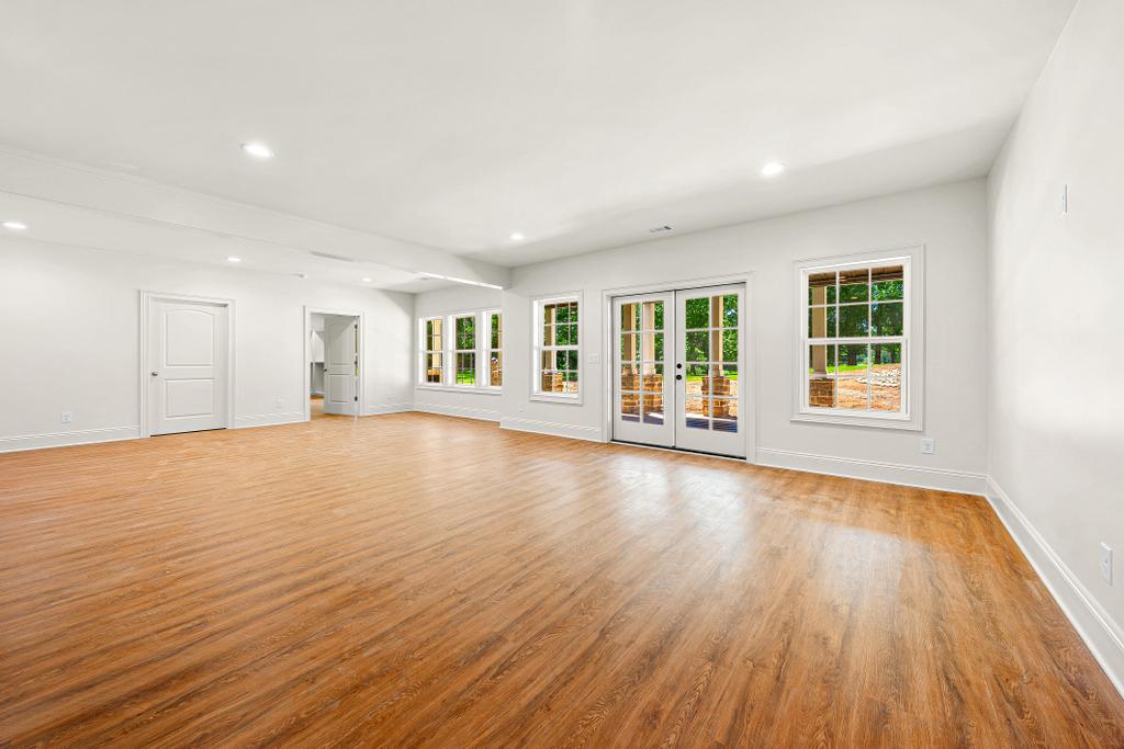 707 Vickery Street Extension Hartwell, GA 30643 - Photo 36 of 50 Ample natural light illuminates this spacious interior, highlighting the durable, warm-toned flooring.