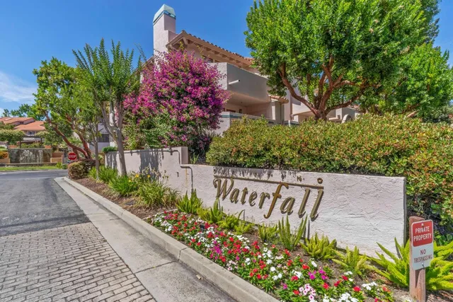 a sign that is in front of flowers