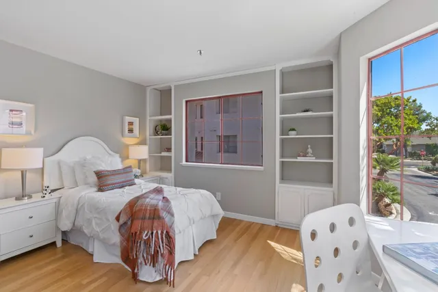 a bedroom with a bed and a window