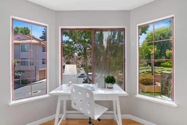 a view of a dining room with a table and chairs