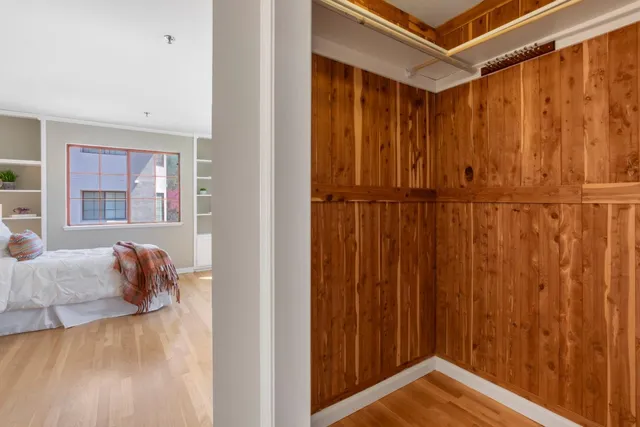 a view of a room with a bed and a window