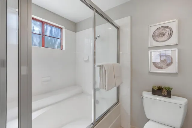 a bathroom with a toilet and a shower