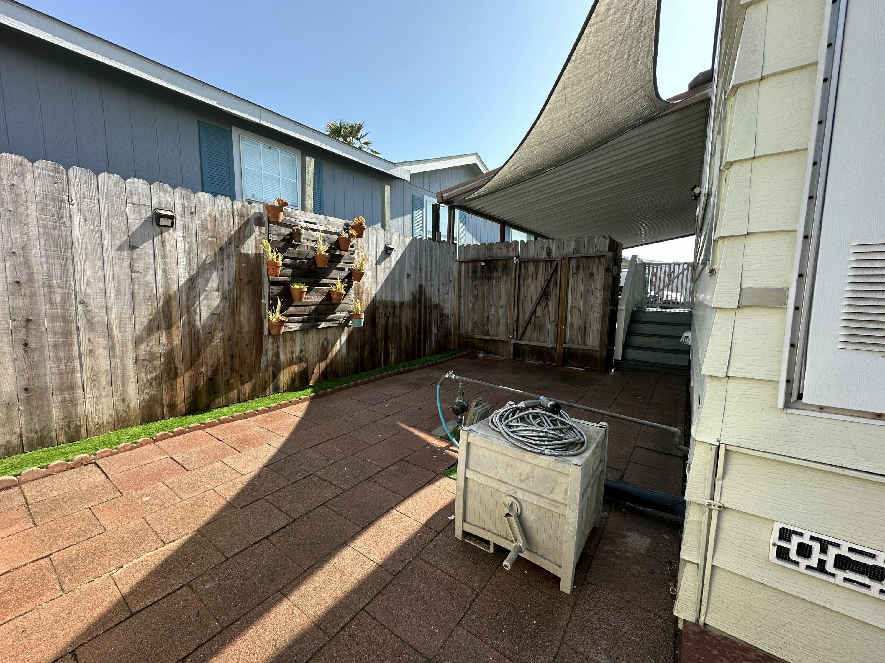5700 Via Real, Unit 75 Carpinteria, CA 93013 - Photo 15 of 20 a view of a deck with table and chairs with wooden floor