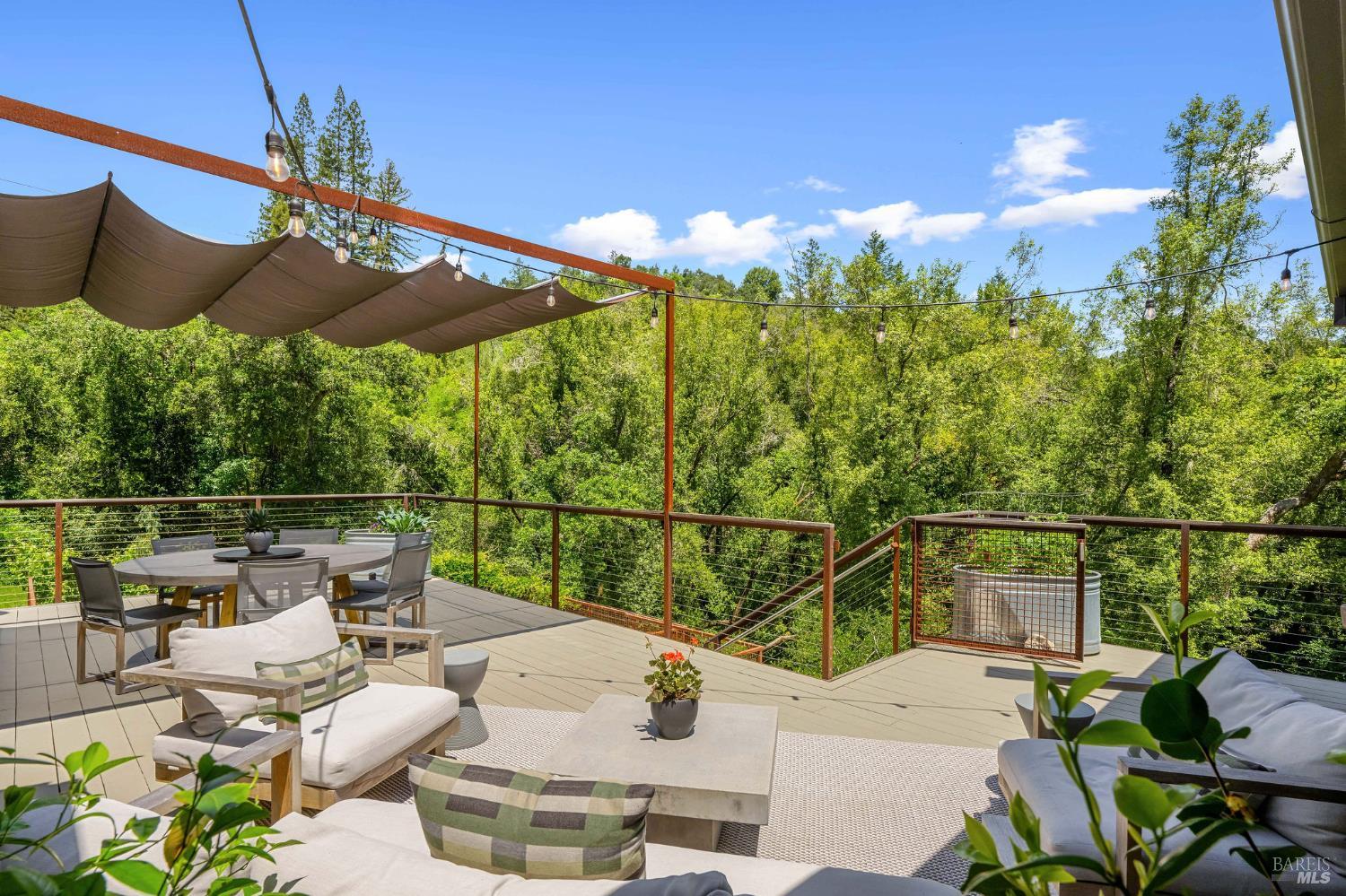 4504 Redwood Road Napa, CA 94558 - Photo 42 of 57 a roof deck with table and chairs under an umbrella