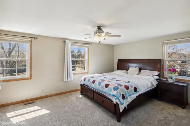 a bedroom with a bed rug and window