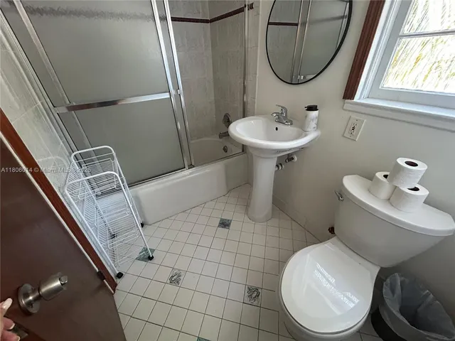 a bathroom with a sink toilet and a mirror