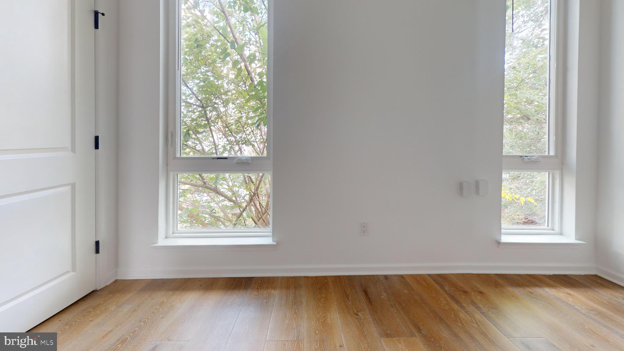 5225 Walnut Street, Unit 4 Philadelphia, PA 19139 - Photo 3 of 5 an empty room with wooden floor and windows