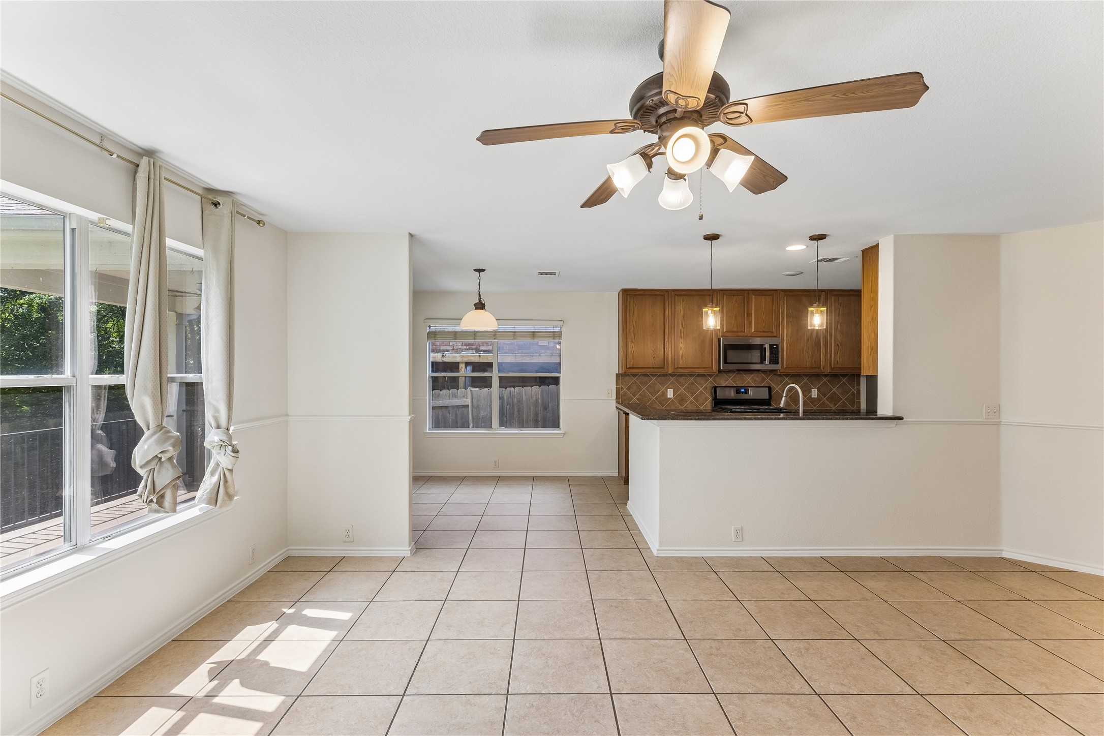 2372 Paradise Ridge Drive Round Rock, TX 78665 - Photo 40 of 40 An open floorplan seamlessly connects the well-lit living area to a practical kitchen space.