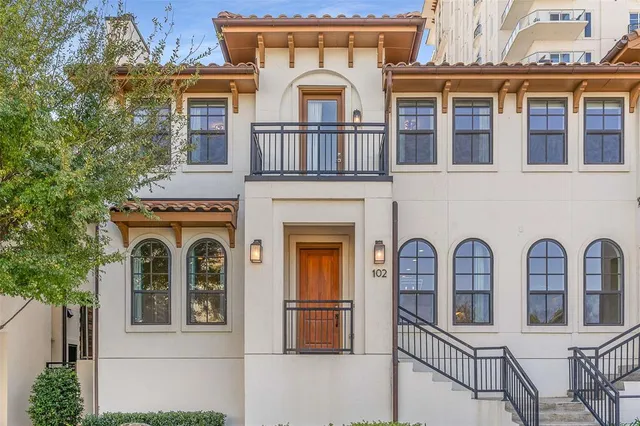 a front view of a house with iron gate