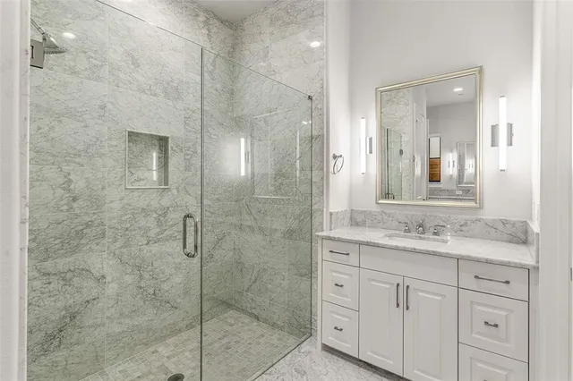 a spacious bathroom with a granite countertop sink a bathtub and a mirror