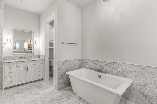 a kitchen with stainless steel appliances white cabinets and a sink