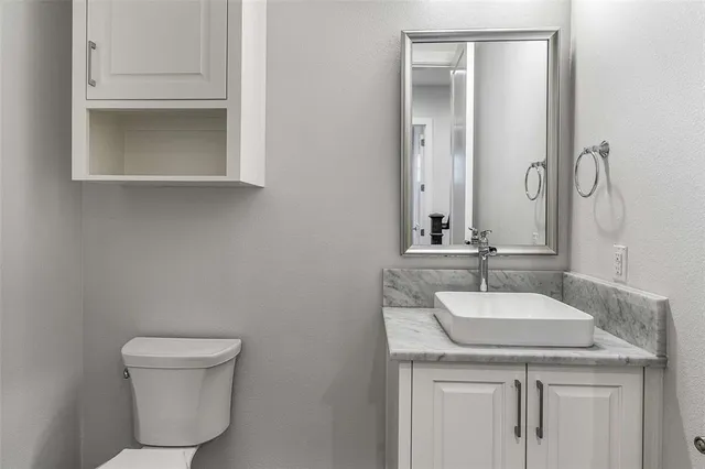 a view of an empty room with wooden floor and a flat screen tv