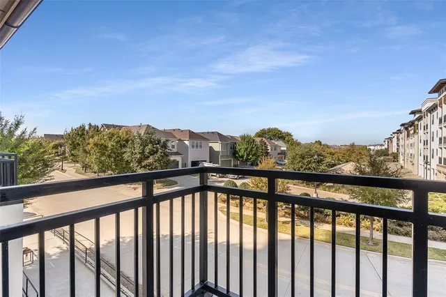 a living room with furniture a flat screen tv and kitchen view