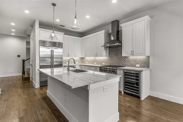 a kitchen with stainless steel appliances granite countertop a sink stove and cabinets