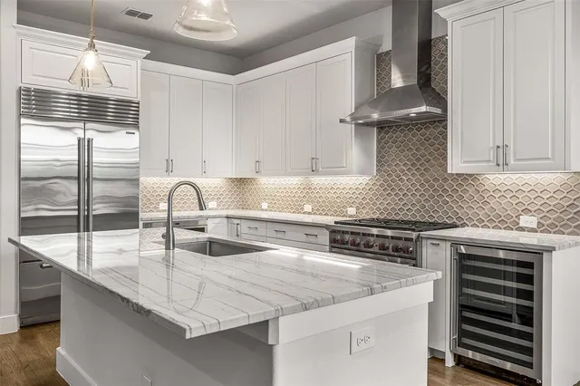 a kitchen with stainless steel appliances granite countertop a stove a sink and a granite counter tops