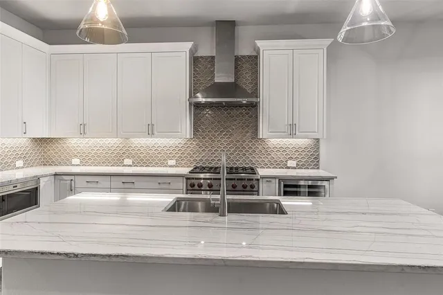 a view of a kitchen with a sink and a flat screen tv