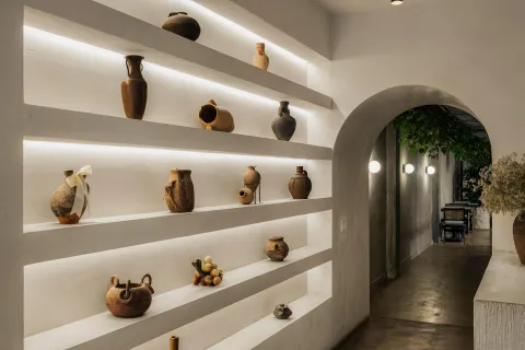 a hallway with dining area and chandelier