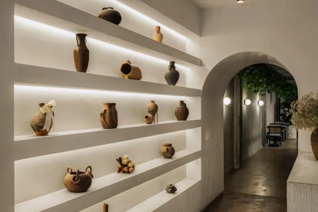 a hallway with dining area and chandelier