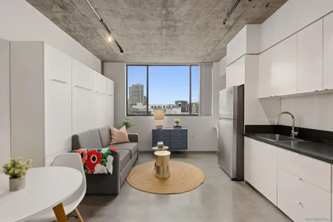 a kitchen that has a sink and a stove top oven