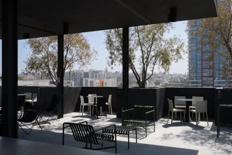 a kitchen with a sink a stove and wooden cabinets