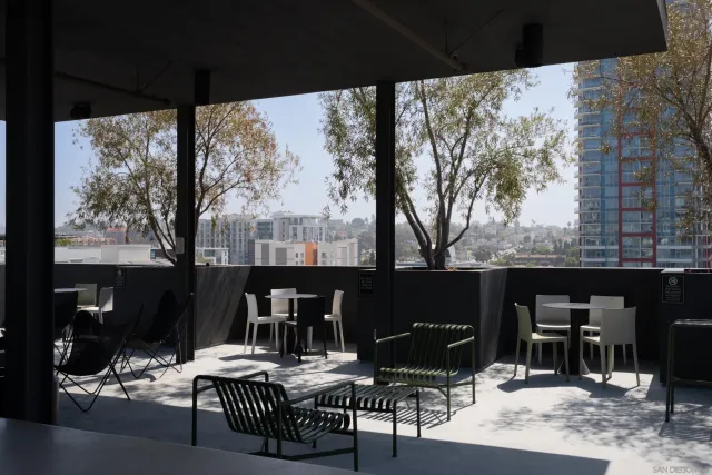 a kitchen with a sink a stove and wooden cabinets