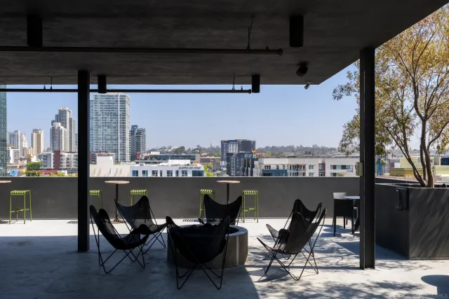 a balcony with table and chairs