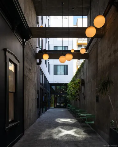 a view of a porch with chairs and potted plants