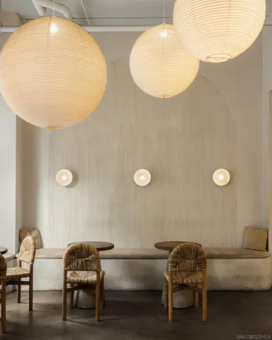 a living room with a table and chairs