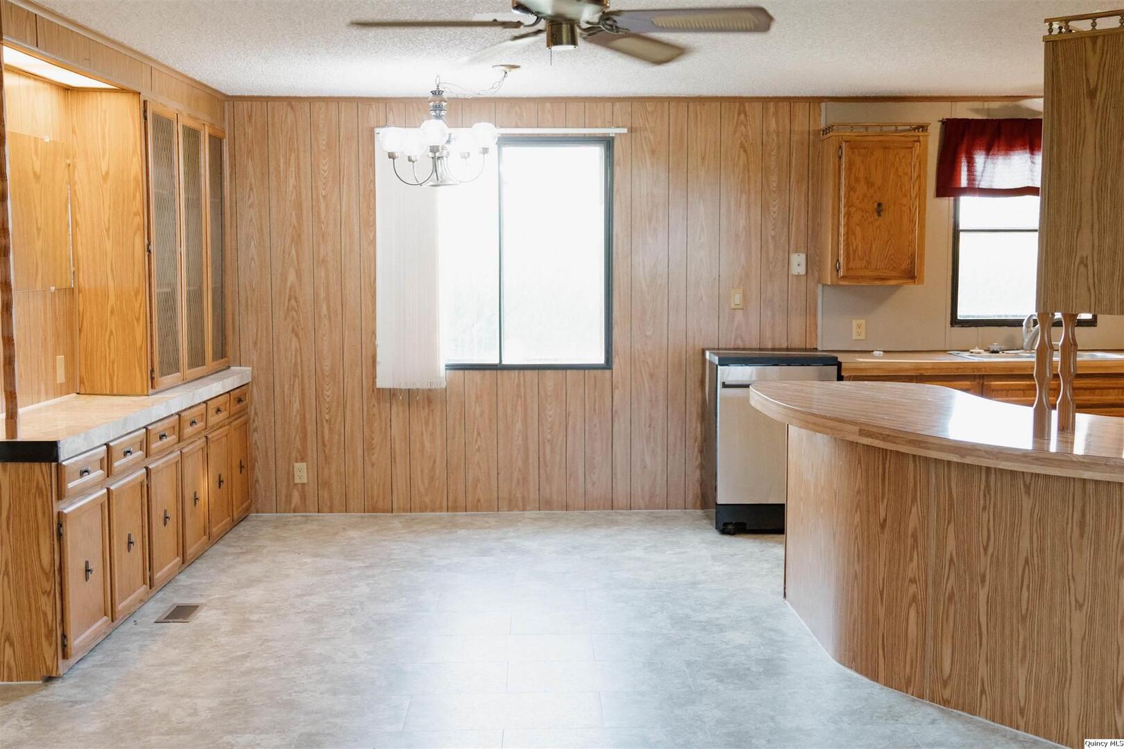2217 County Road 2000 North Camp Point, IL 62320 - Photo 2 of 7 a bathroom with a sink a window and a mirror