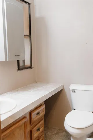 a white toilet sitting next to a bathroom sink
