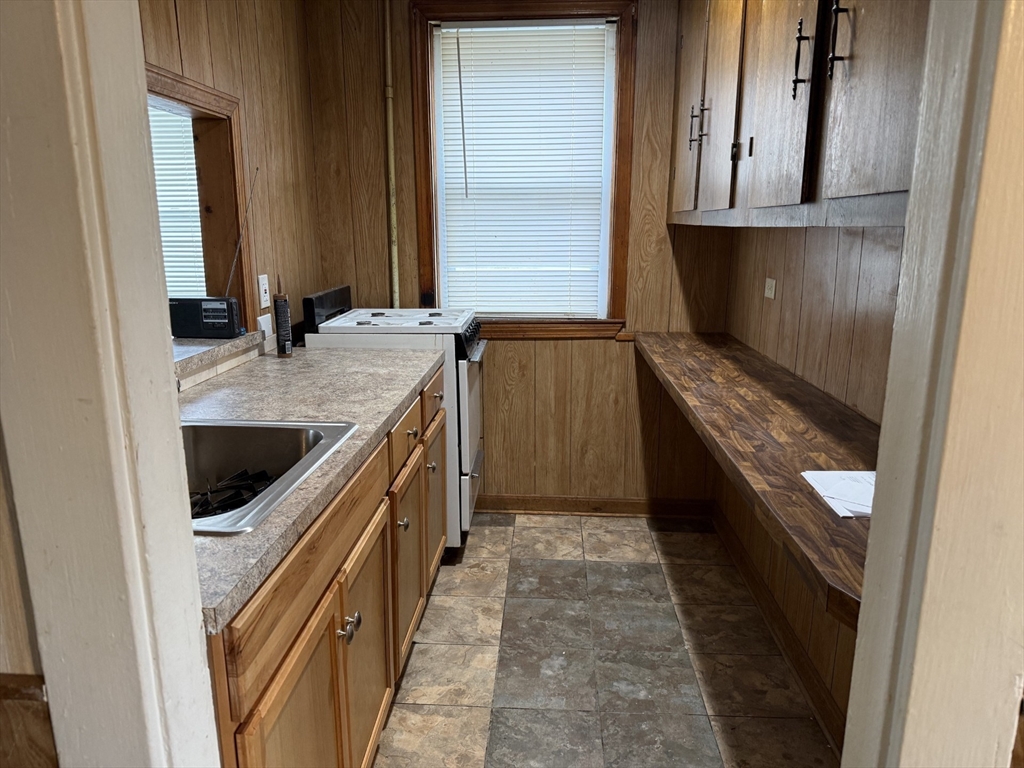 9 Lexington Street, Unit 1W Fall River, MA 02723 - Photo 2 of 10 a bathroom with a granite countertop sink a vanity and a mirror