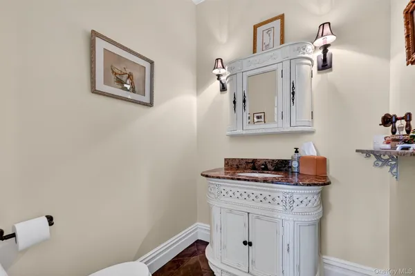 a bathroom with a stove a sink and cabinets