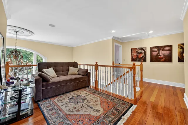 a spacious bedroom with a bed and wooden floor