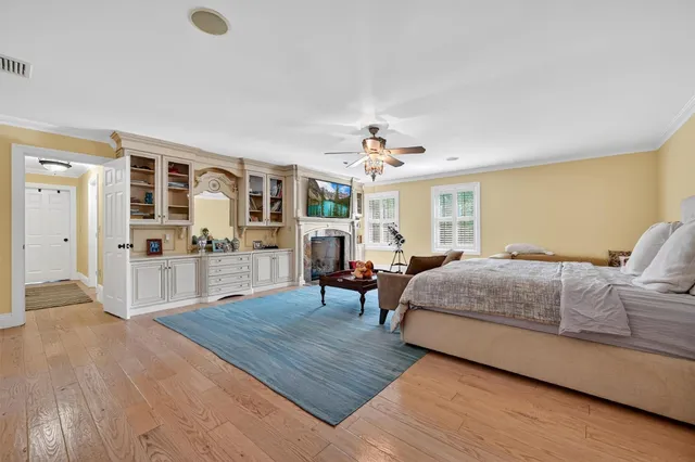 a spacious bedroom with a bed and a fireplace