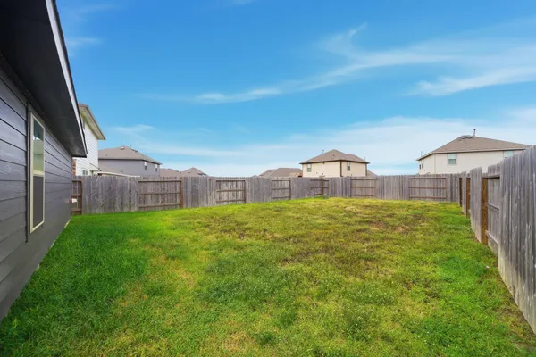 a view of a house with a backyard