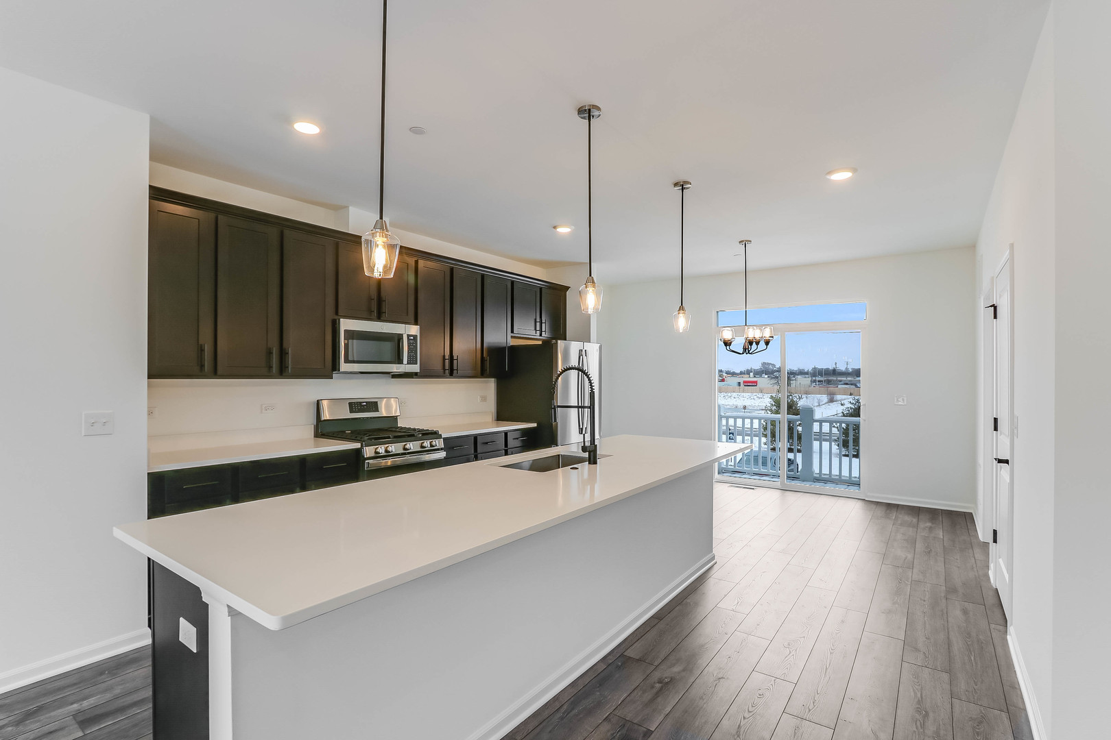 1552 Slade Way Des Plaines, IL 60018 - Photo 11 of 32 a kitchen with stainless steel appliances a stove a sink a center island and a wooden floor