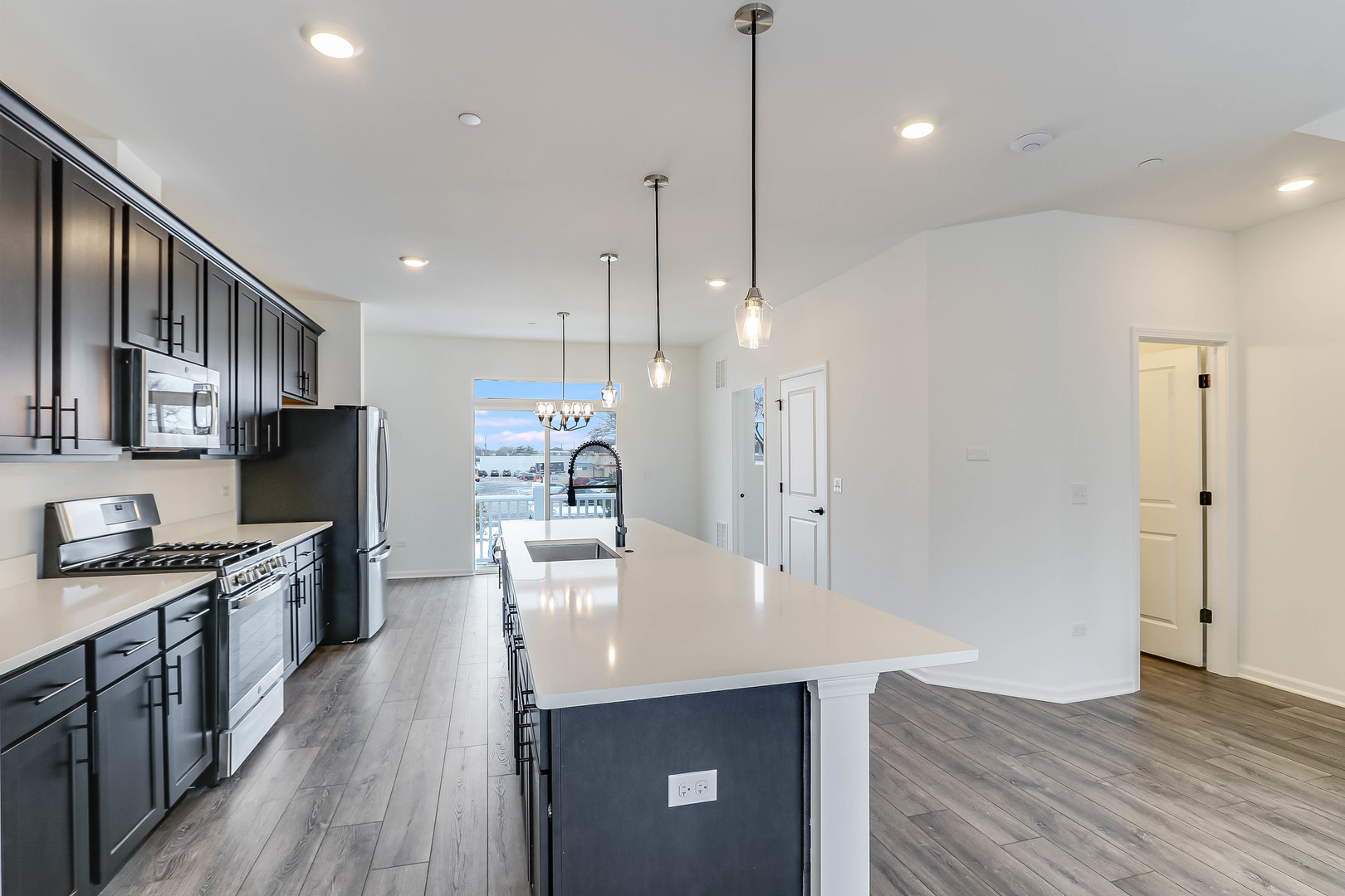 1552 Slade Way Des Plaines, IL 60018 - Photo 12 of 32 a kitchen with stainless steel appliances a kitchen island a stove and a wooden floor
