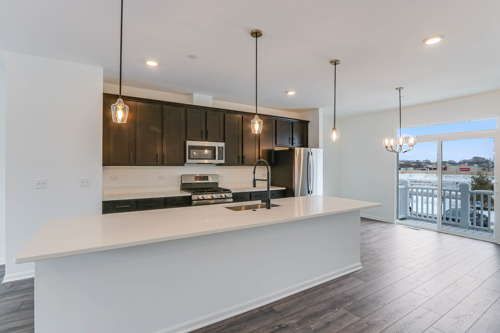 1552 Slade Way Des Plaines, IL 60018 - Photo 13 of 32 a kitchen with stainless steel appliances a sink a stove a refrigerator a center island a stove and wooden floor