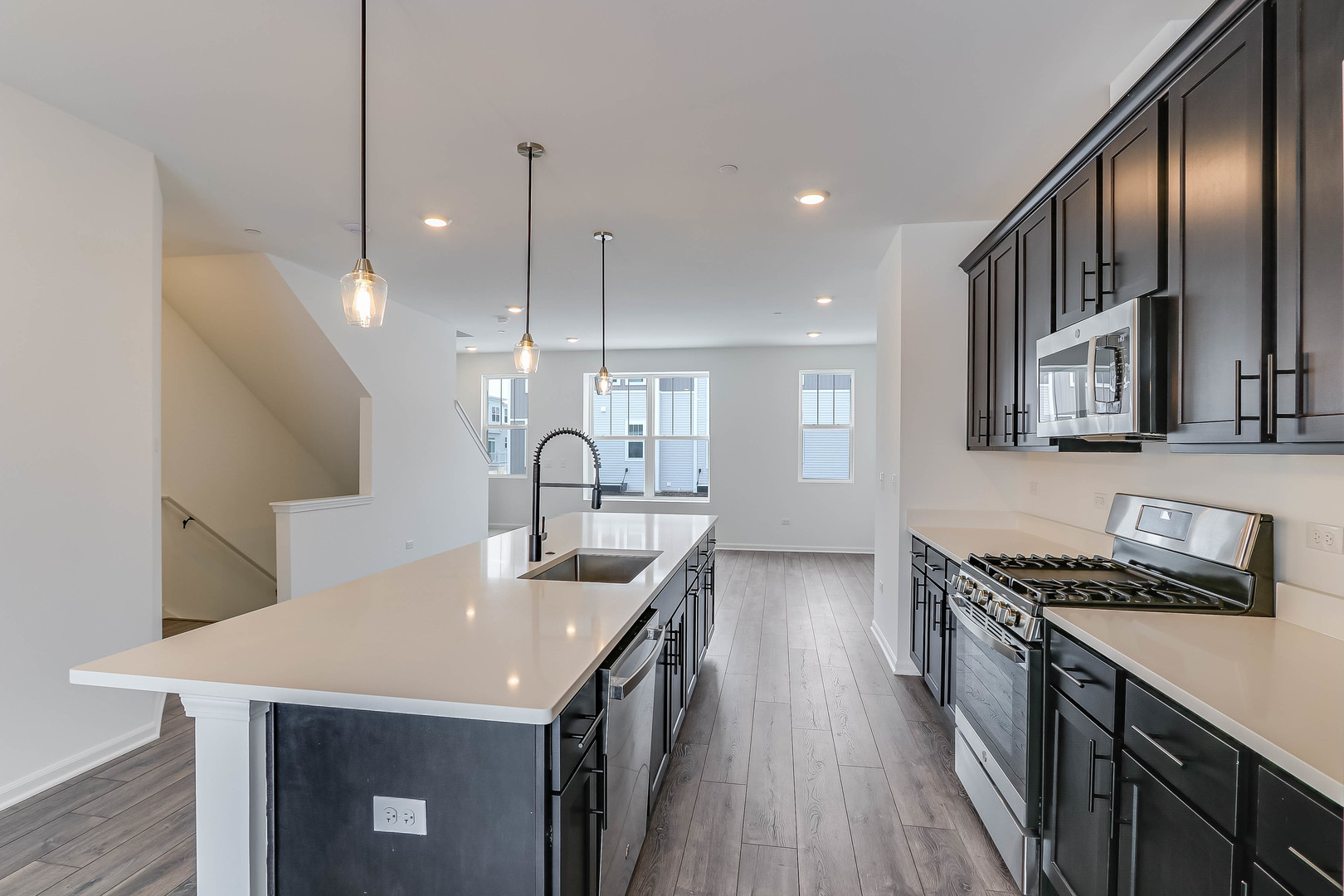1552 Slade Way Des Plaines, IL 60018 - Photo 15 of 32 a kitchen with stainless steel appliances granite countertop a sink a stove and a wooden floors