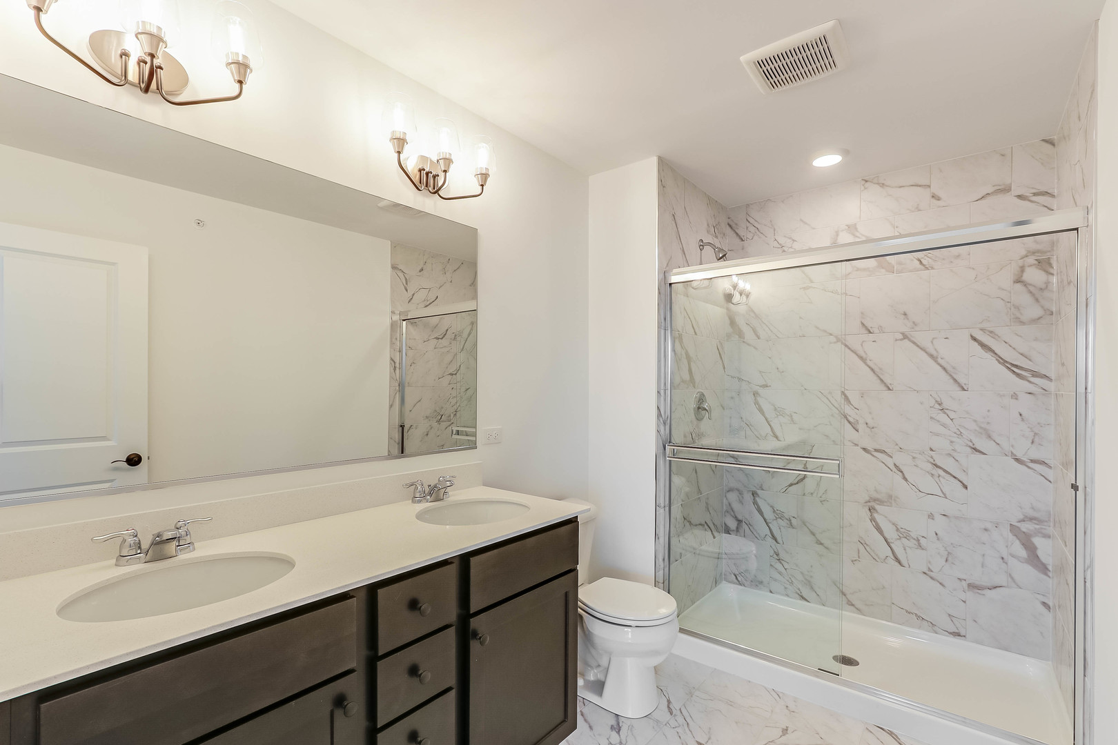 1552 Slade Way Des Plaines, IL 60018 - Photo 23 of 32 a bathroom with a sink a toilet a mirror and shower