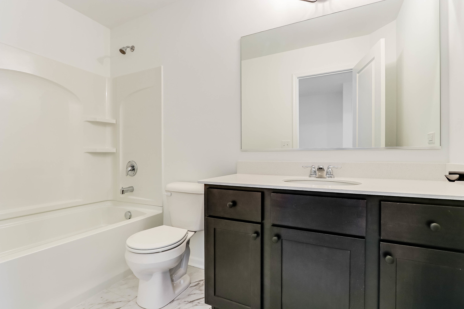 1552 Slade Way Des Plaines, IL 60018 - Photo 27 of 32 a bathroom with a toilet a sink a mirror and a bathtub