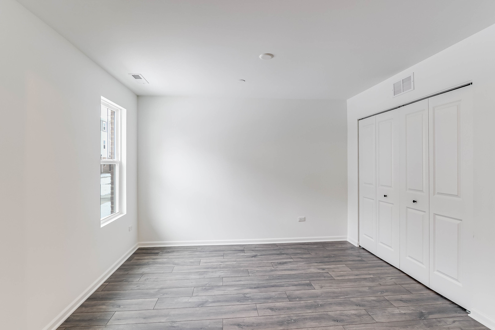 1552 Slade Way Des Plaines, IL 60018 - Photo 3 of 32 an empty room with wooden floor and windows