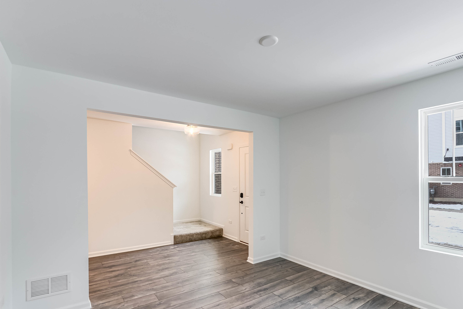 1552 Slade Way Des Plaines, IL 60018 - Photo 5 of 32 an empty room with wooden floor and windows