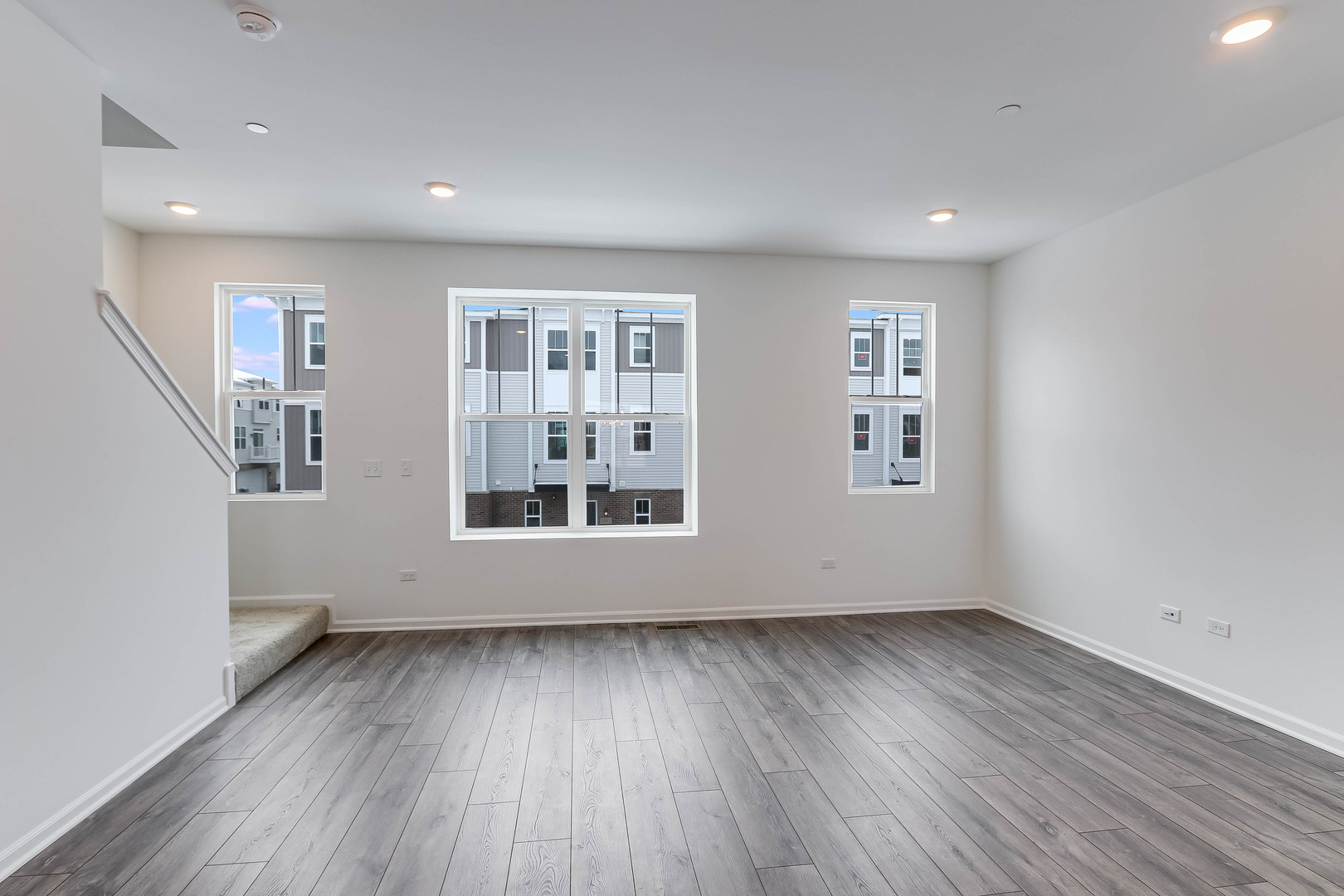 1552 Slade Way Des Plaines, IL 60018 - Photo 7 of 32 an empty room with wooden floor and windows