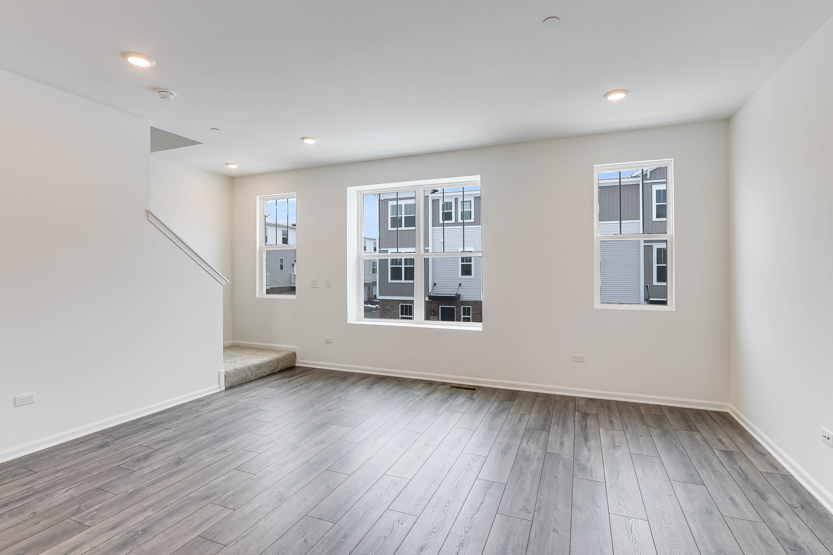 1552 Slade Way Des Plaines, IL 60018 - Photo 8 of 32 a view of an empty room with wooden floor and a window