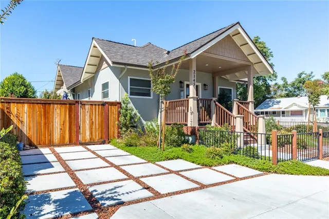 a front view of a house with a garden