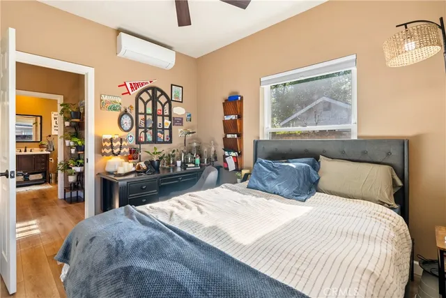 a bedroom with a bed and a painting on the wall